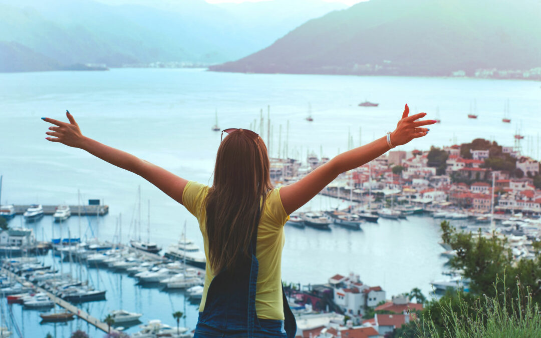 Woman with hands in the air overlooking Yachts in Turkey